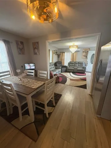 a view of a dining room with furniture wooden floor and chandelier