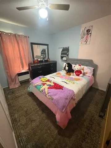 a bedroom with bed and window