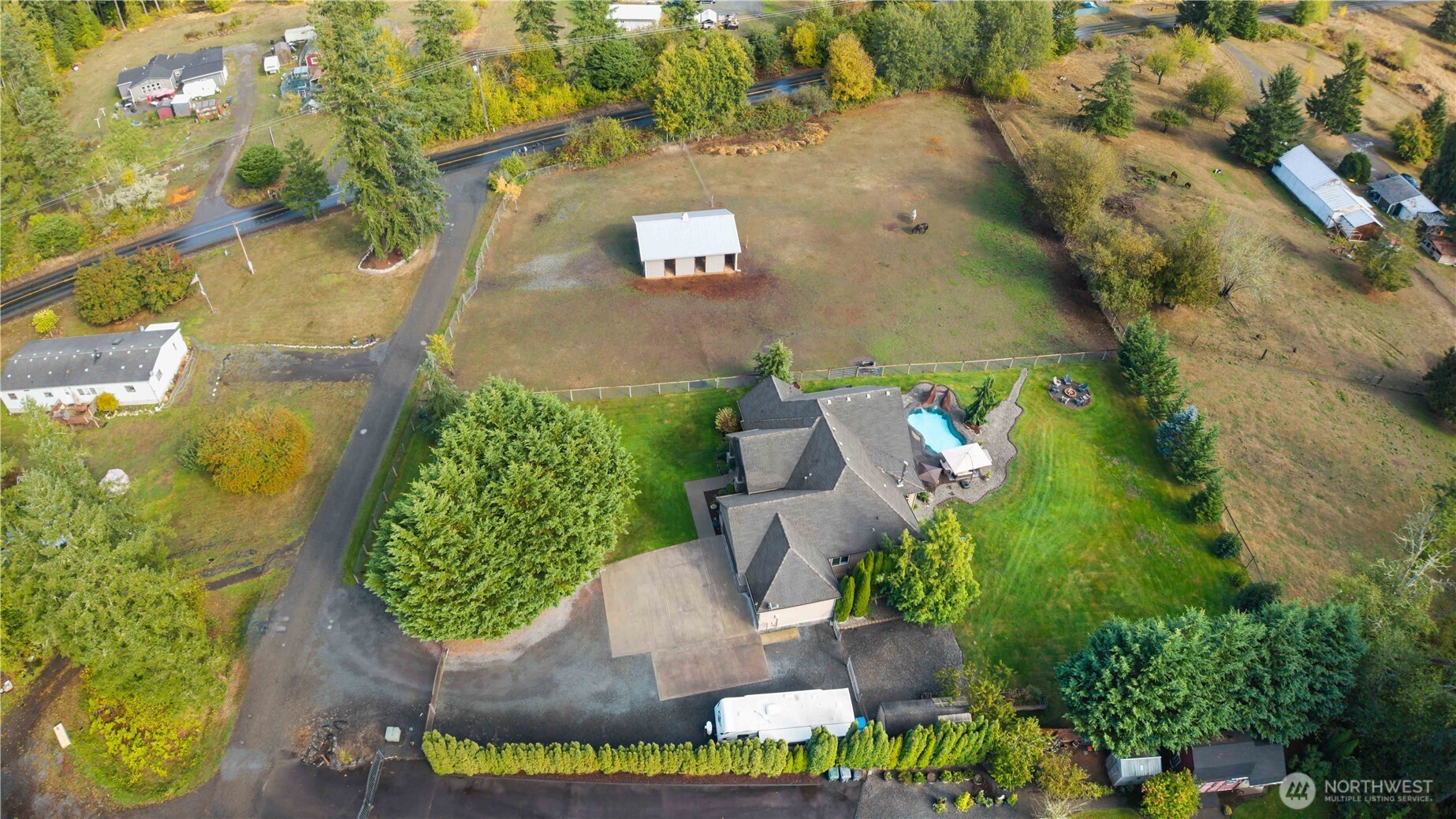 an aerial view of a house with yard swimming pool and outdoor seating