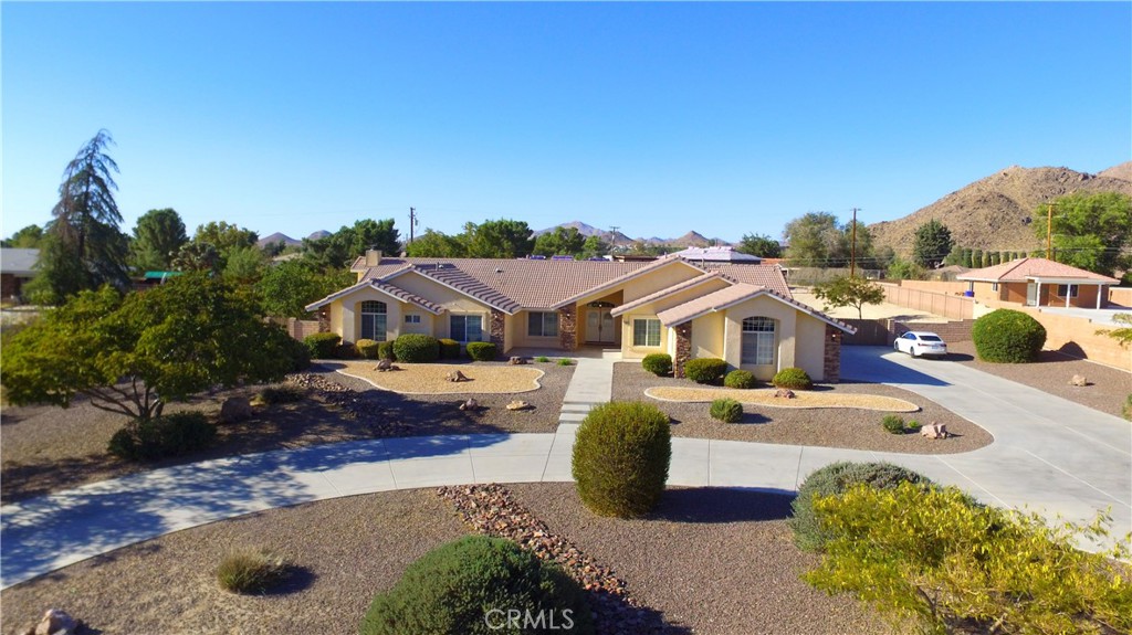 19640 Yanan Road Apple Valley, CA 92307 - Photo 1 of 1 a aerial view of a house with swimming pool and large trees