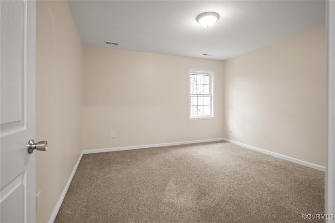 2919 Hog Back Road Hopewell, VA 23860 - Photo 27 of 45 Spare room with visible vents, baseboards, and car