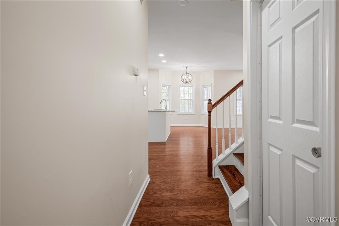 2919 Hog Back Road Hopewell, VA 23860 - Photo 8 of 45 Hallway with a chandelier, dark wood-style floorin