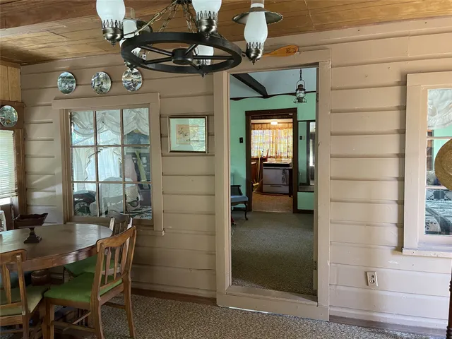 a bedroom with two beds and windows