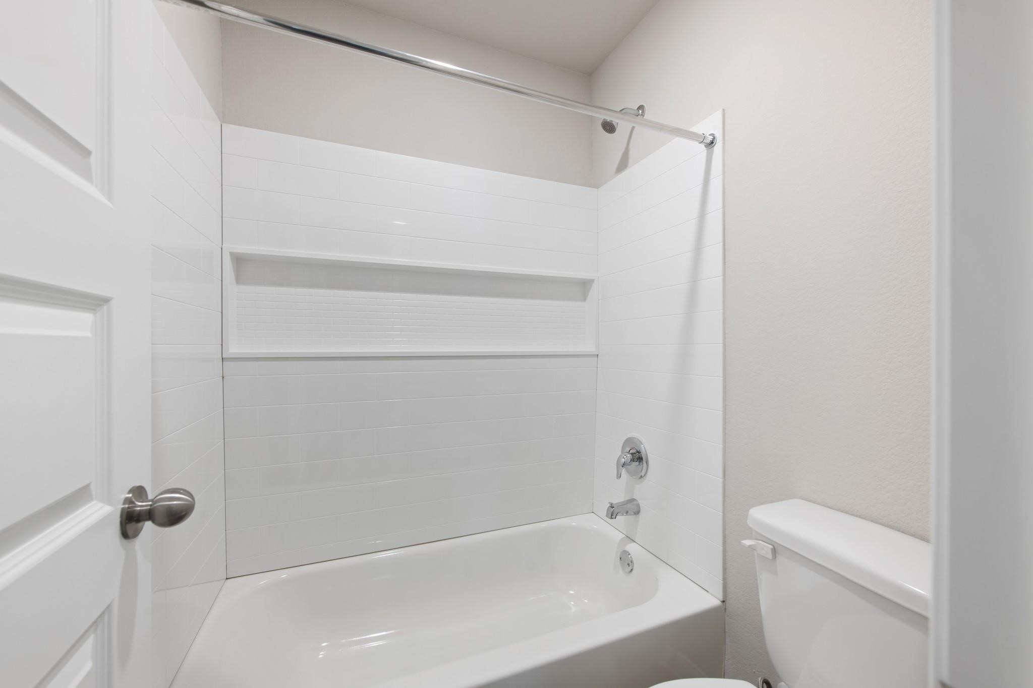 506 Moose Run Huntsville, TX 77320 - Photo 18 of 26 a bathroom with a bathtub and a toilet