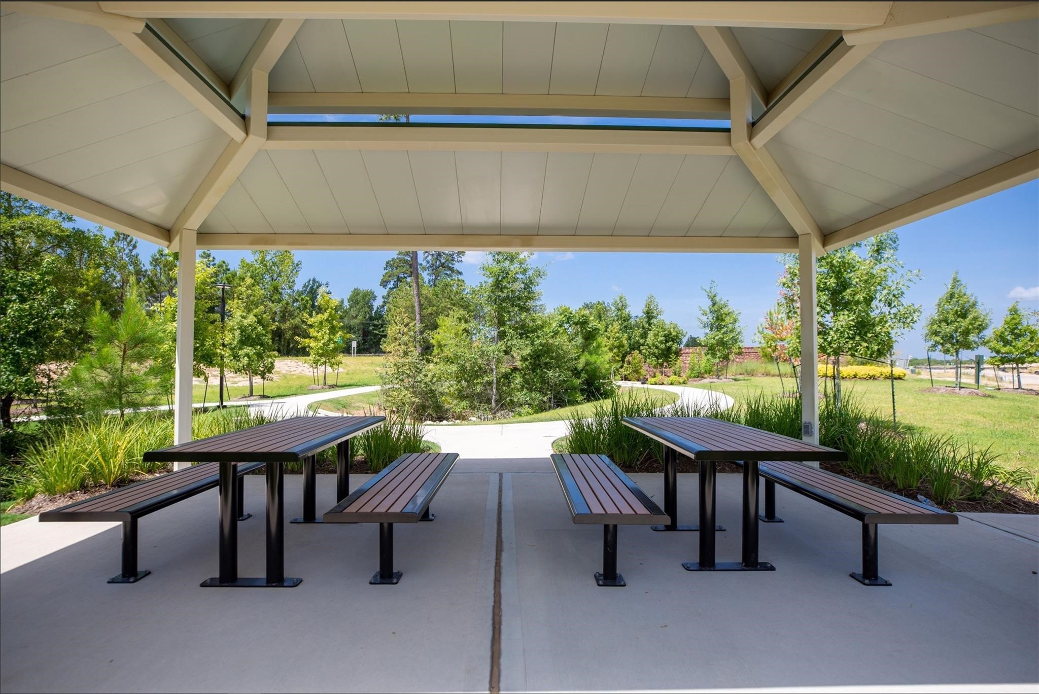 506 Moose Run Huntsville, TX 77320 - Photo 24 of 26 a view of a patio with table and chairs potted plants with a garden