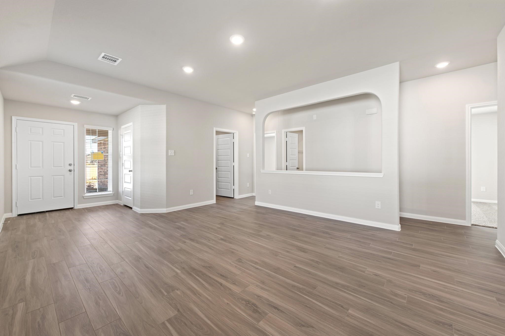 506 Moose Run Huntsville, TX 77320 - Photo 4 of 26 a view of wooden floor and windows in an empty room