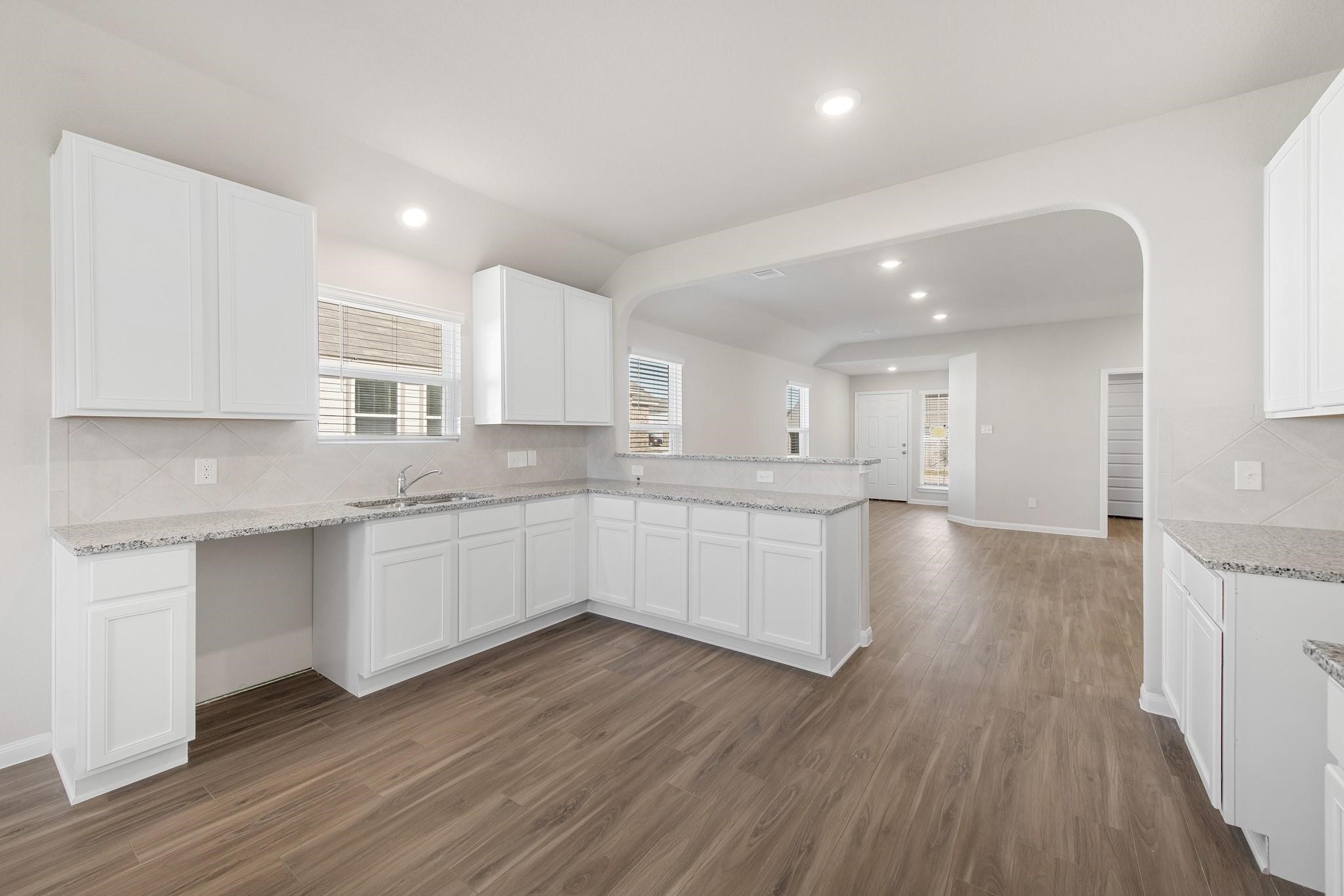 506 Moose Run Huntsville, TX 77320 - Photo 5 of 26 a large kitchen with a lot of counter space and wooden floor