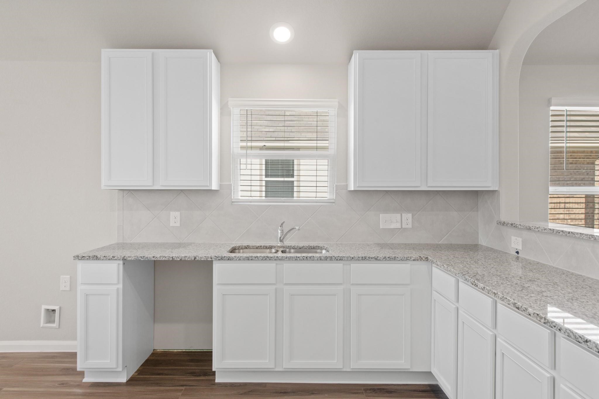 506 Moose Run Huntsville, TX 77320 - Photo 8 of 26 a kitchen with granite countertop white cabinets and a sink
