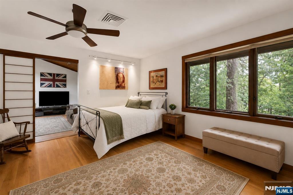 34 Cambridge Way Alpine, NJ 07620 - Photo 24 of 48 a spacious bedroom with a bed and a large window