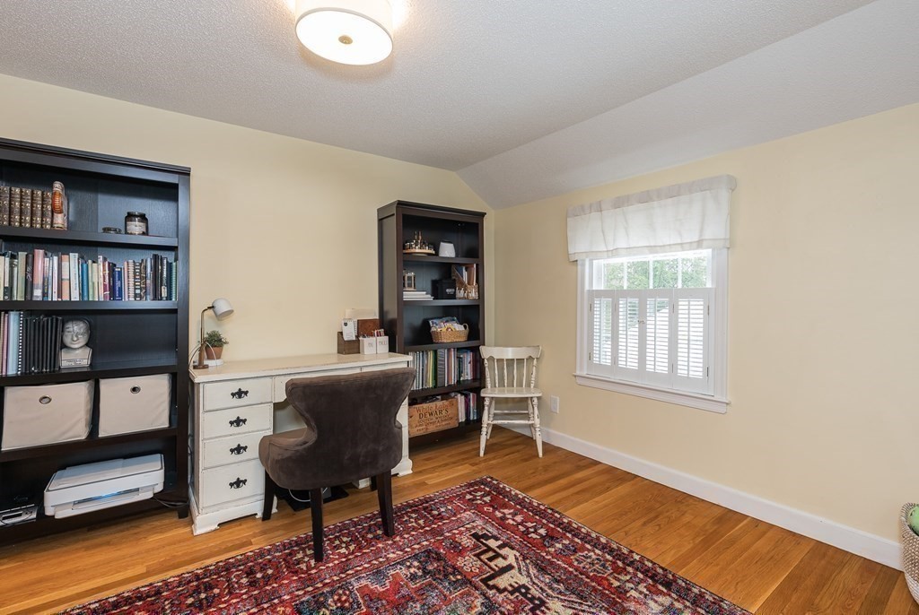 97 Bridle Path Road Springfield, MA 01118 - Photo 31 of 42 a living room with furniture and a book shelf
