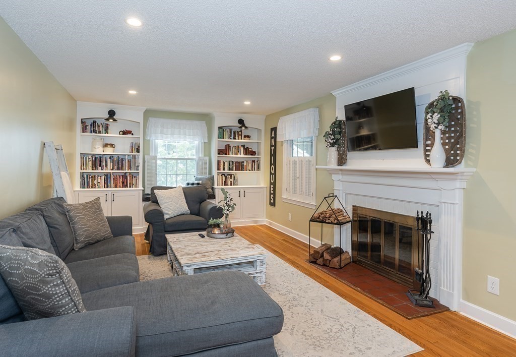 97 Bridle Path Road Springfield, MA 01118 - Photo 6 of 42 a living room with furniture a flat screen tv and a fireplace
