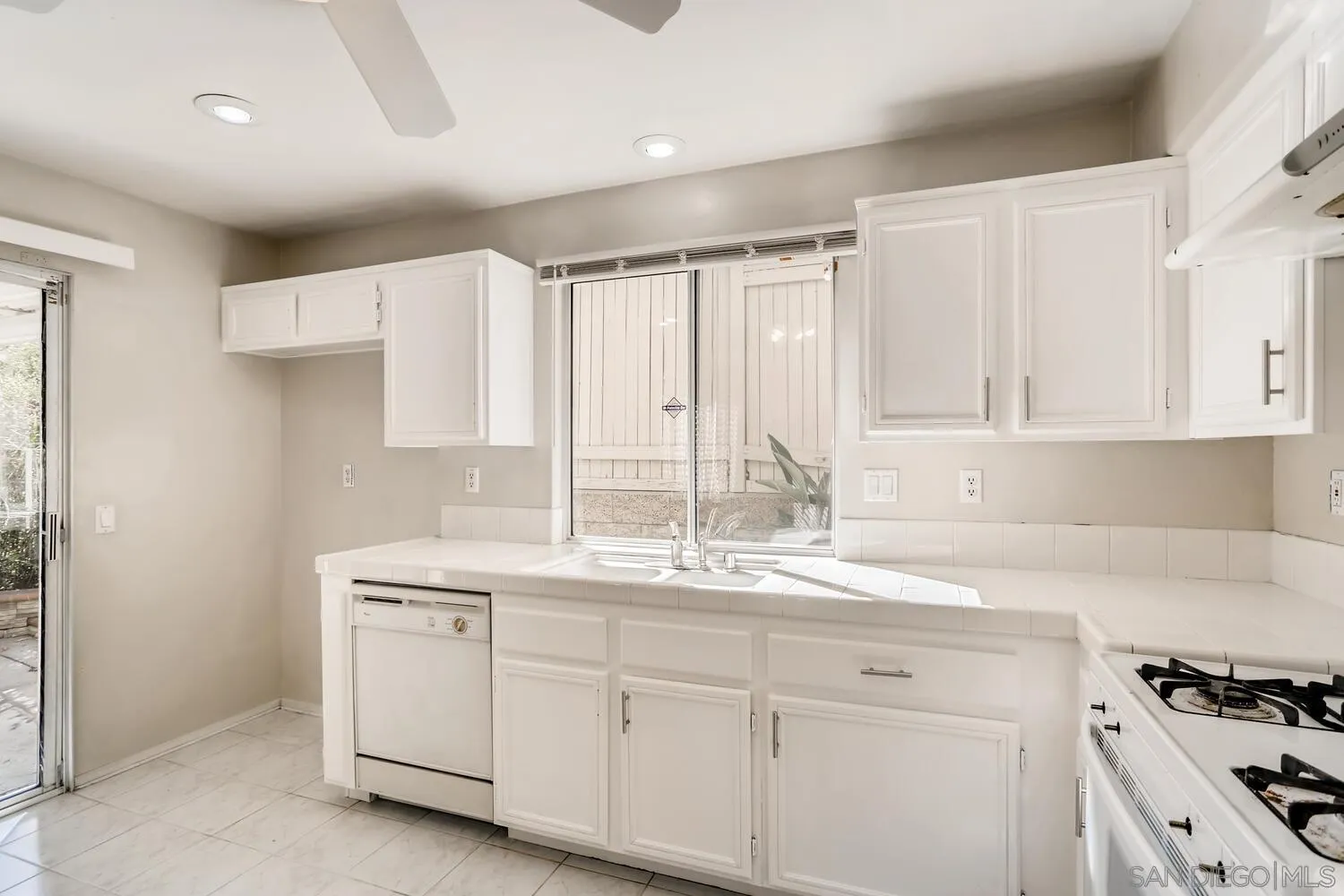 545 Shenandoah Road Corona, CA 92879 - Photo 3 of 11 a kitchen with granite countertop white cabinets and white appliances