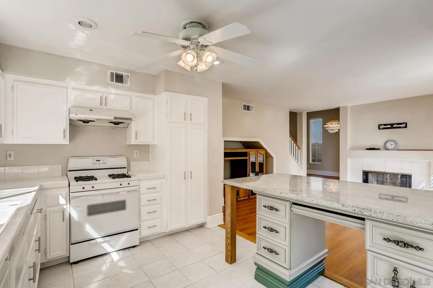 545 Shenandoah Road Corona, CA 92879 - Photo 4 of 11 a kitchen with granite countertop a sink a stove and cabinets