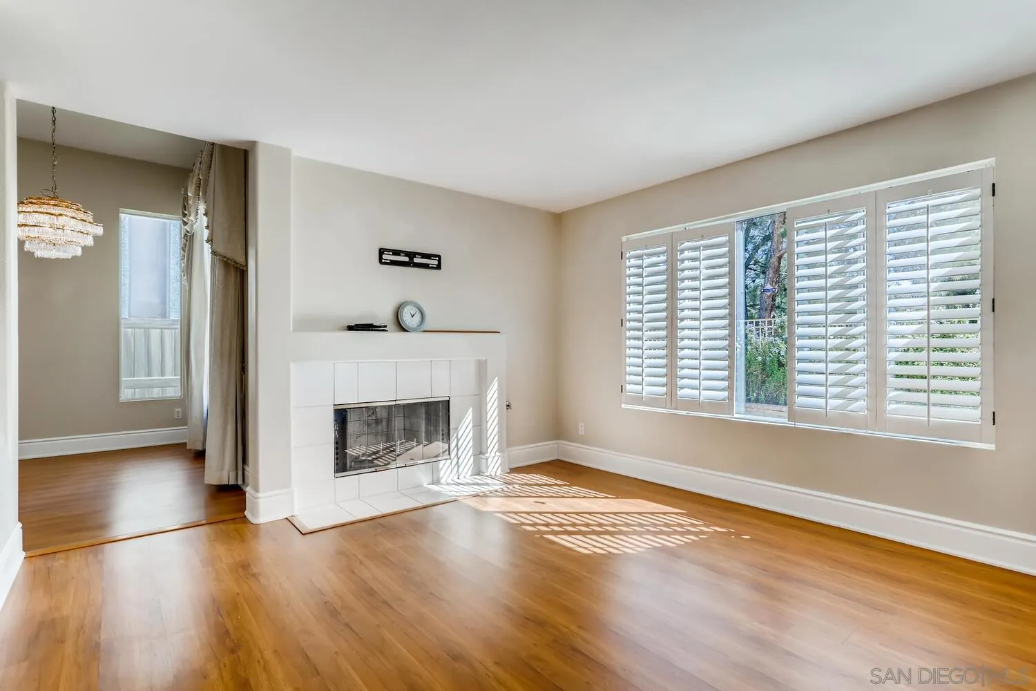 545 Shenandoah Road Corona, CA 92879 - Photo 5 of 11 an empty room with wooden floor fireplace and windows