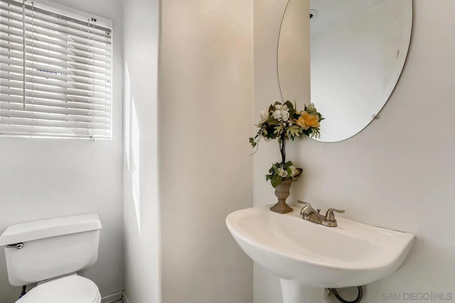 545 Shenandoah Road Corona, CA 92879 - Photo 6 of 11 a bathroom with a sink toilet and a mirror