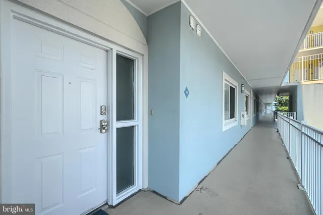 a dining room with furniture a potted plant and a chandelier