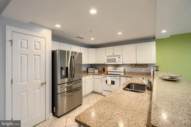 a view of a dining room with furniture and a chandelier