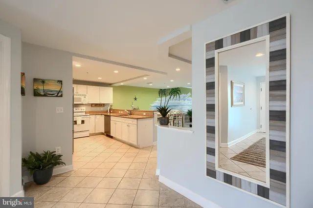 a large kitchen with a table and chairs in it
