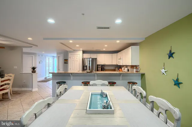 a living room with furniture a rug and a chandelier