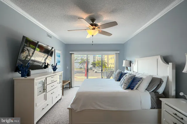 a bedroom with a large bed and a dresser