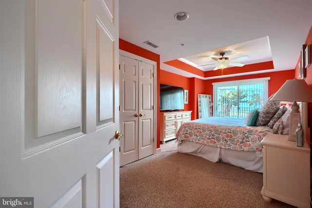 a front view of a building with a garden and plants