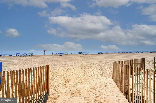 a kitchen with granite countertop a sink and white stainless steel appliances