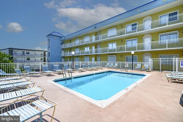 a kitchen with stainless steel appliances a stove a sink a oven a dining table and chairs