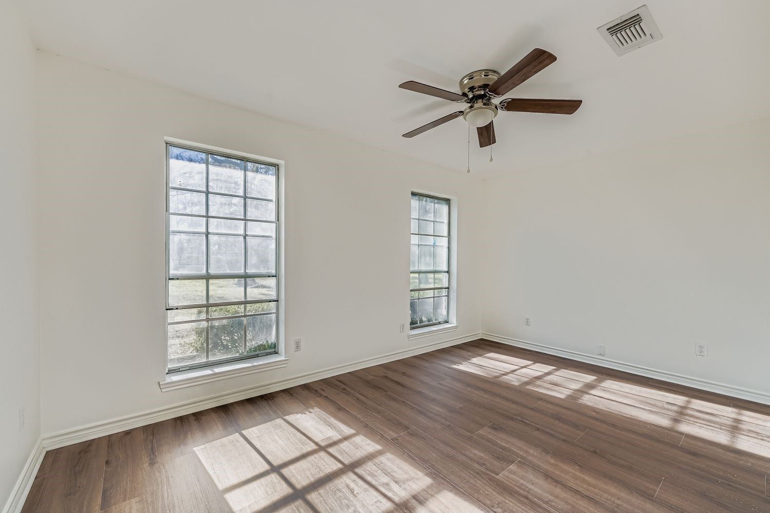 34411 Fulshear Farms Road Fulshear, TX 77441 - Photo 19 of 29 a view of empty room with wooden floor and fan