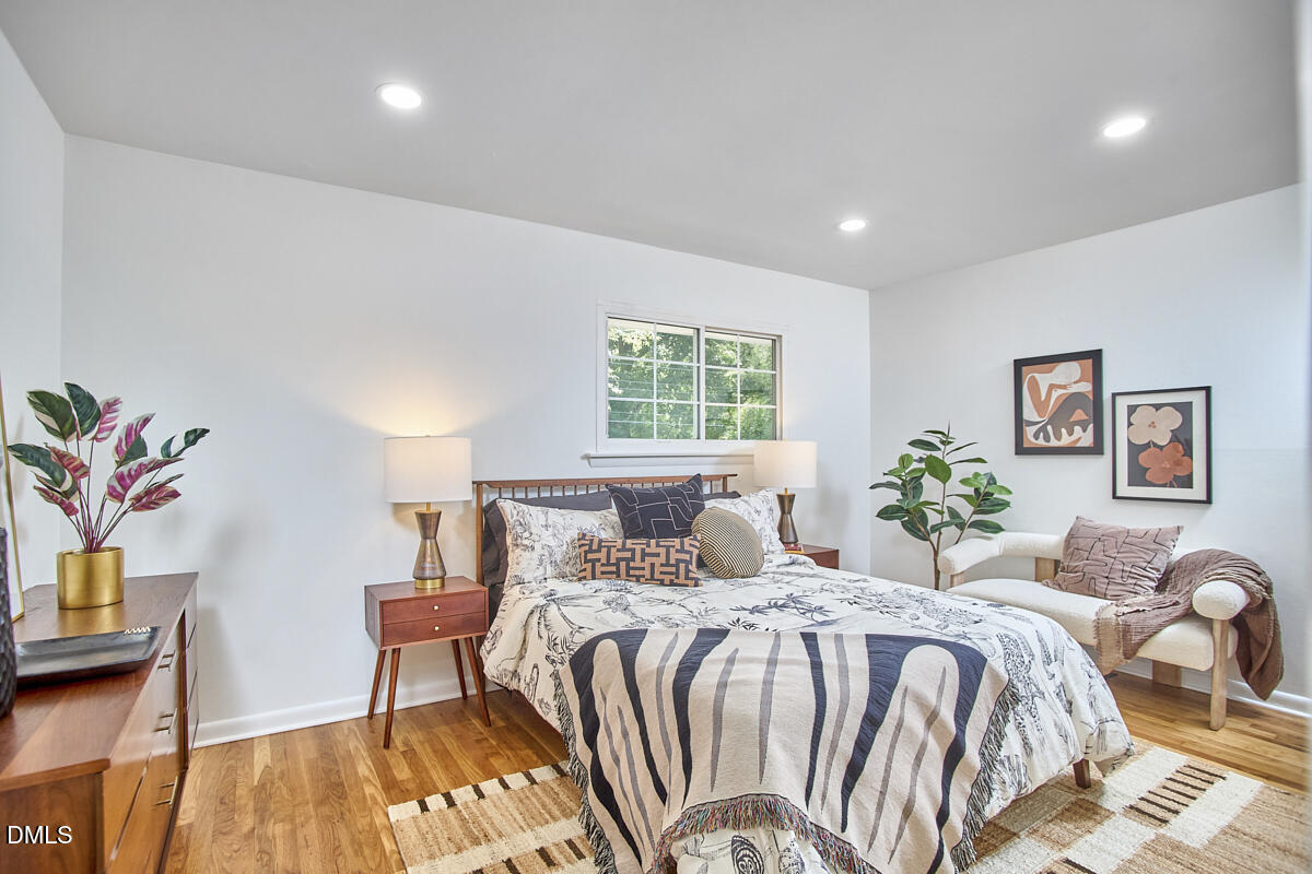 2613 McNeil Street, Unit E Raleigh, NC 27608 - Photo 23 of 28 a bedroom with a bed and a table