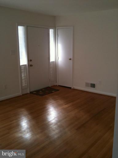 3903 Weller Road Silver Spring, MD 20906 - Photo 1 of 18 an empty room with wooden floor and windows