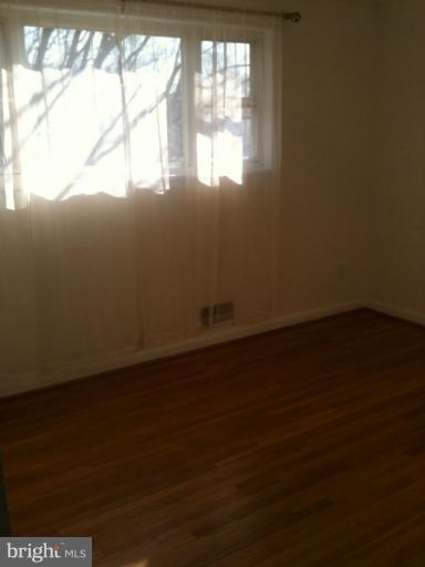 3903 Weller Road Silver Spring, MD 20906 - Photo 7 of 18 a view of empty room with wooden floor and fan