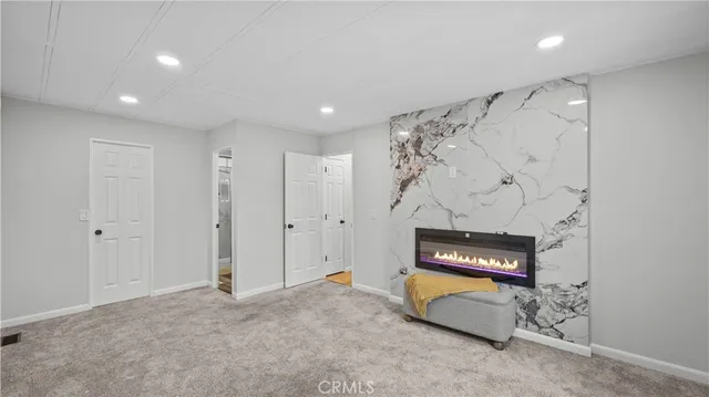 a spacious bedroom with a bed and a walk in closet