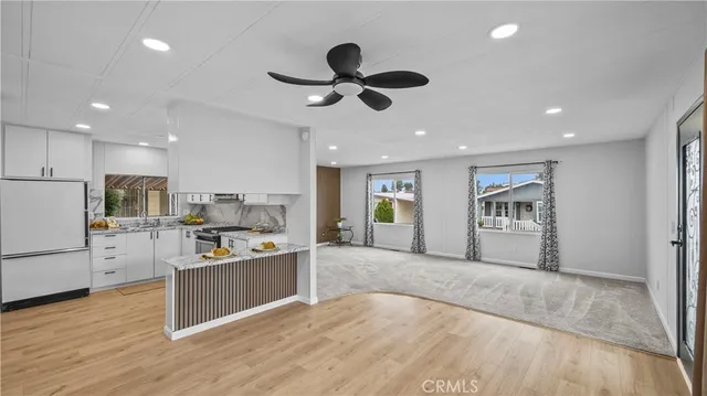 a living room with stainless steel appliances kitchen island granite countertop furniture and a kitchen view