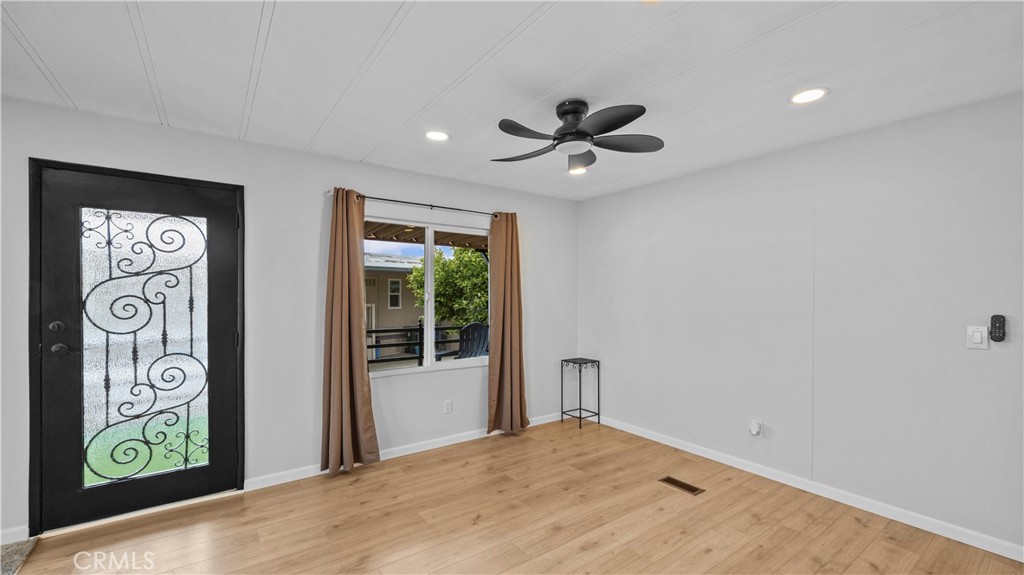 1400 13th Street, Unit 206 Upland, CA 91786 - Photo 6 of 28 a view of empty room with window and ceiling fan