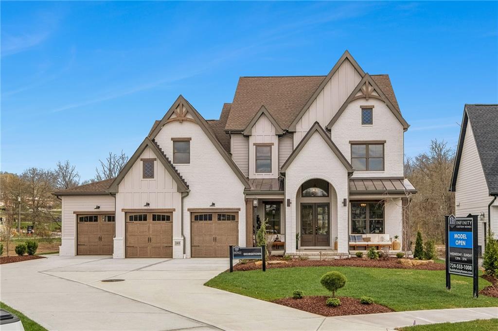 a view of a white house with a big yard and large trees