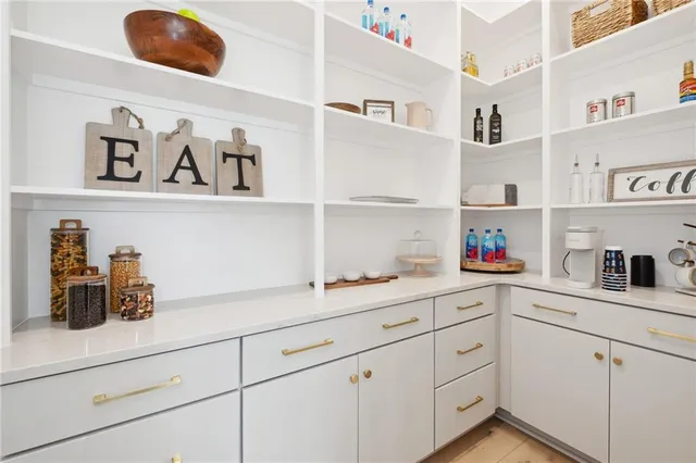 a kitchen with white cabinets and white appliances