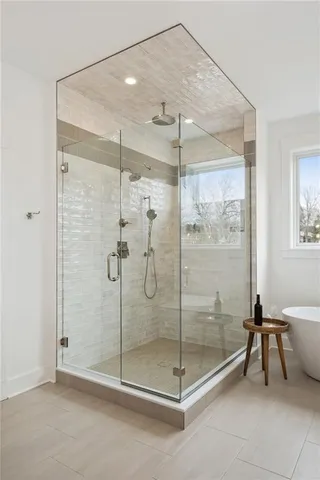 a bathroom that has a glass shower door