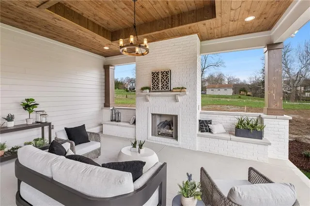 a living room with furniture a fireplace and a floor to ceiling window