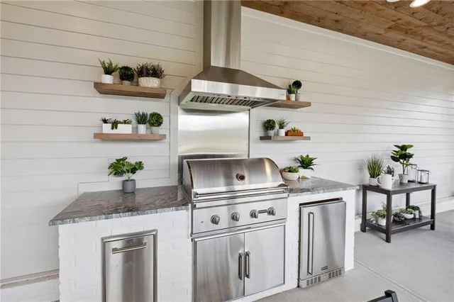 a kitchen with stainless steel appliances granite countertop a sink and cabinets