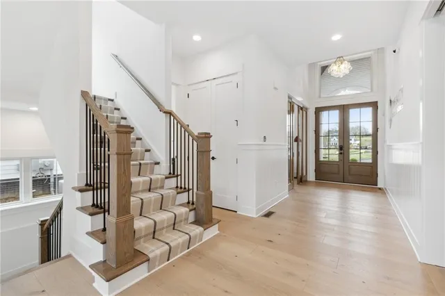 a view of an entryway with wooden floor and windows