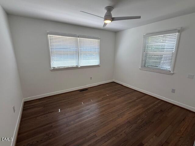 904 Brookwood Drive Raleigh, NC 27607 - Photo 9 of 12 a view of an empty room with wooden floor and a window