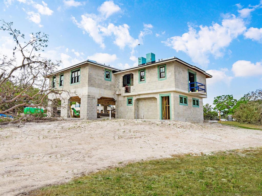 600 North Jackson Road Venice, FL 34292 - Photo 22 of 61 a front view of a house with a yard and garage