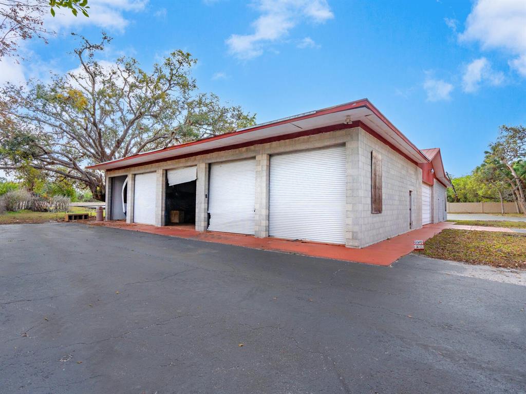 600 North Jackson Road Venice, FL 34292 - Photo 57 of 61 a view of a house with a yard and garage