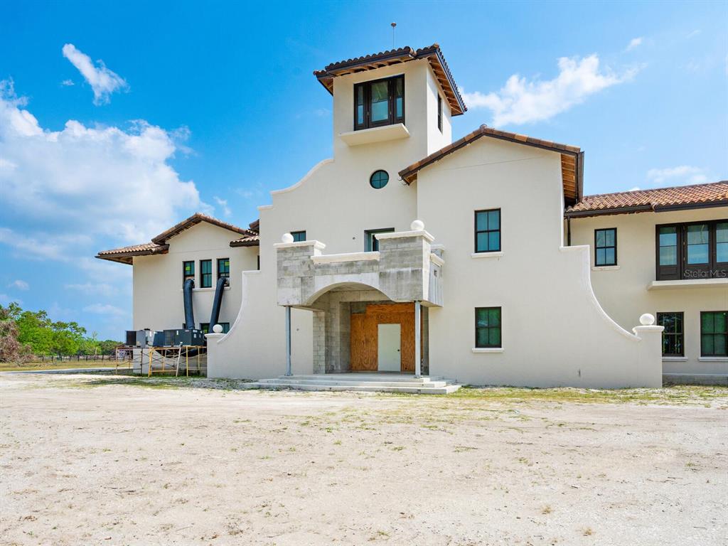 600 North Jackson Road Venice, FL 34292 - Photo 9 of 61 a front view of a house with a yard