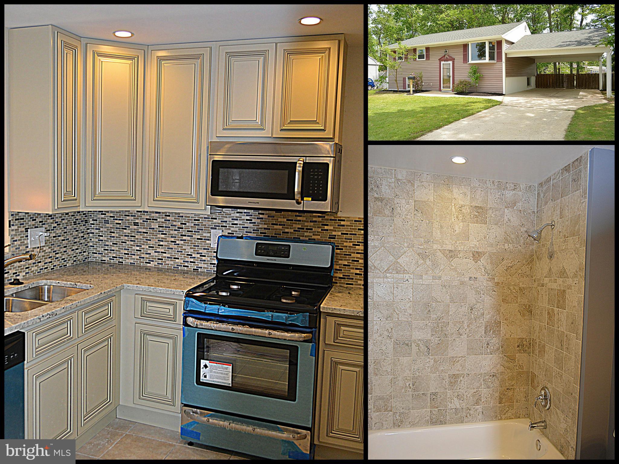 a kitchen with granite countertop a stove and a microwave