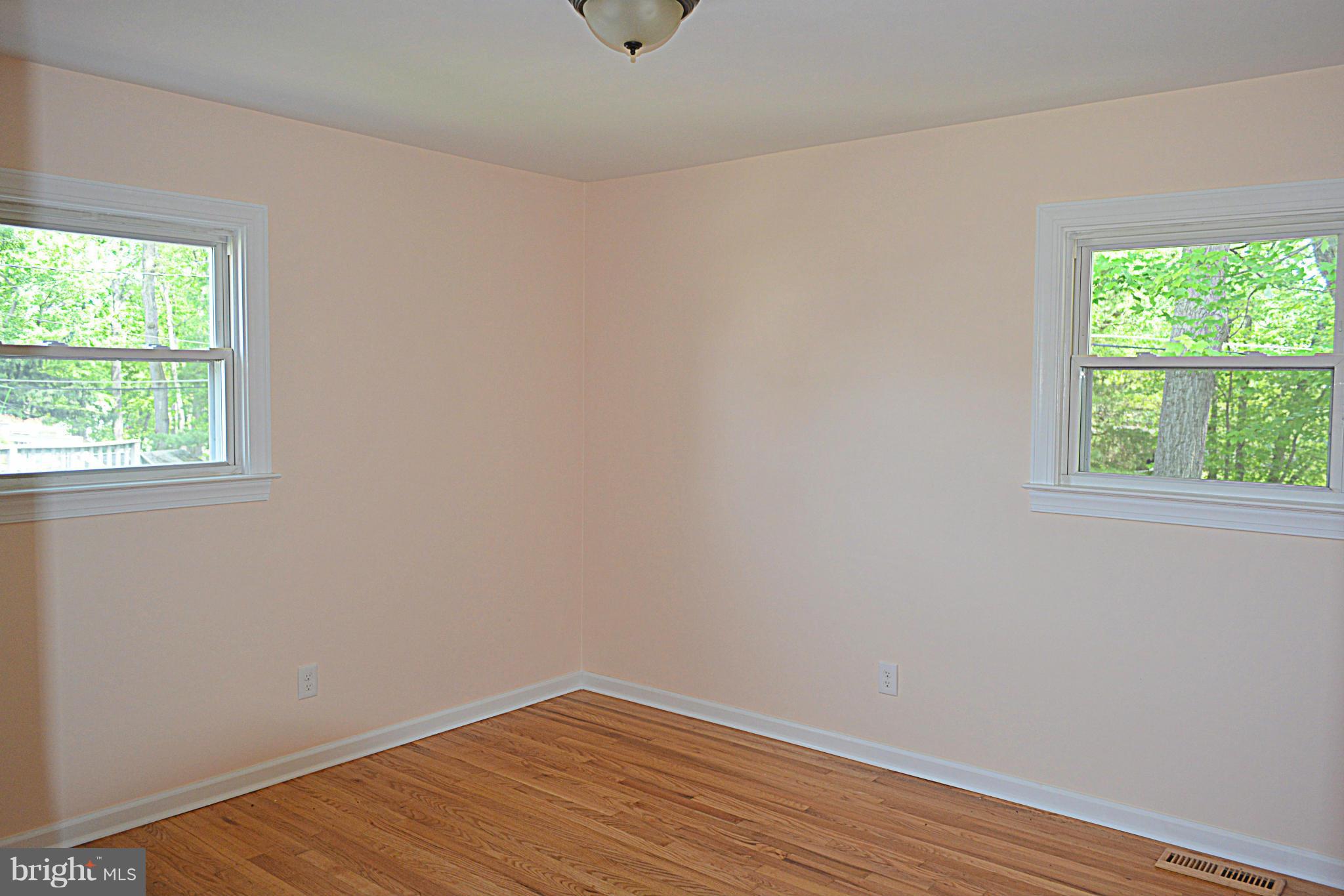 622 Hornbeam Road Edgewood, MD 21040 - Photo 9 of 19 an empty room with wooden floor and windows