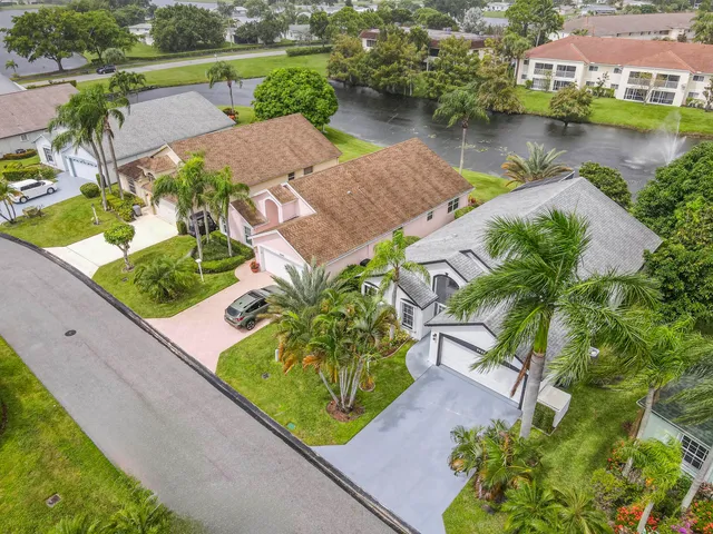 an aerial view of a house with garden space and lake view