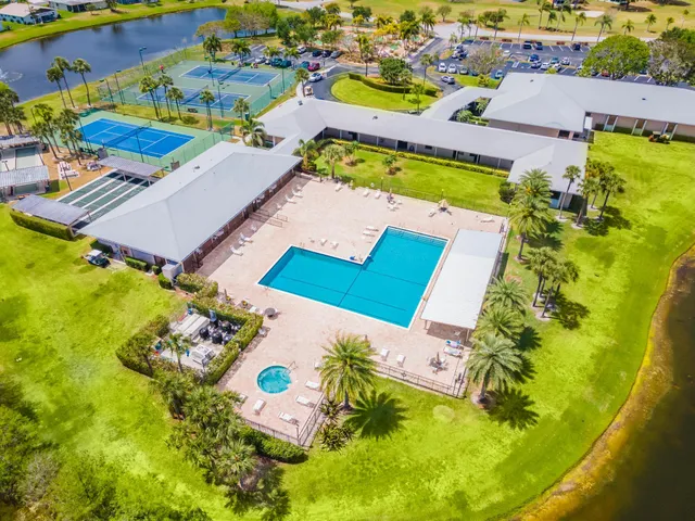 an aerial view of a pool patio chairs and fire pit