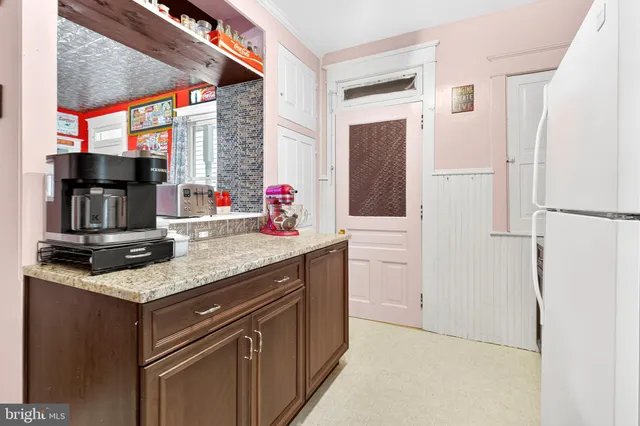 a white refrigerator freezer sitting in a kitchen