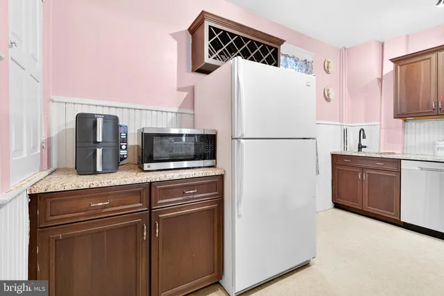 a view of a hallway with a view of living room